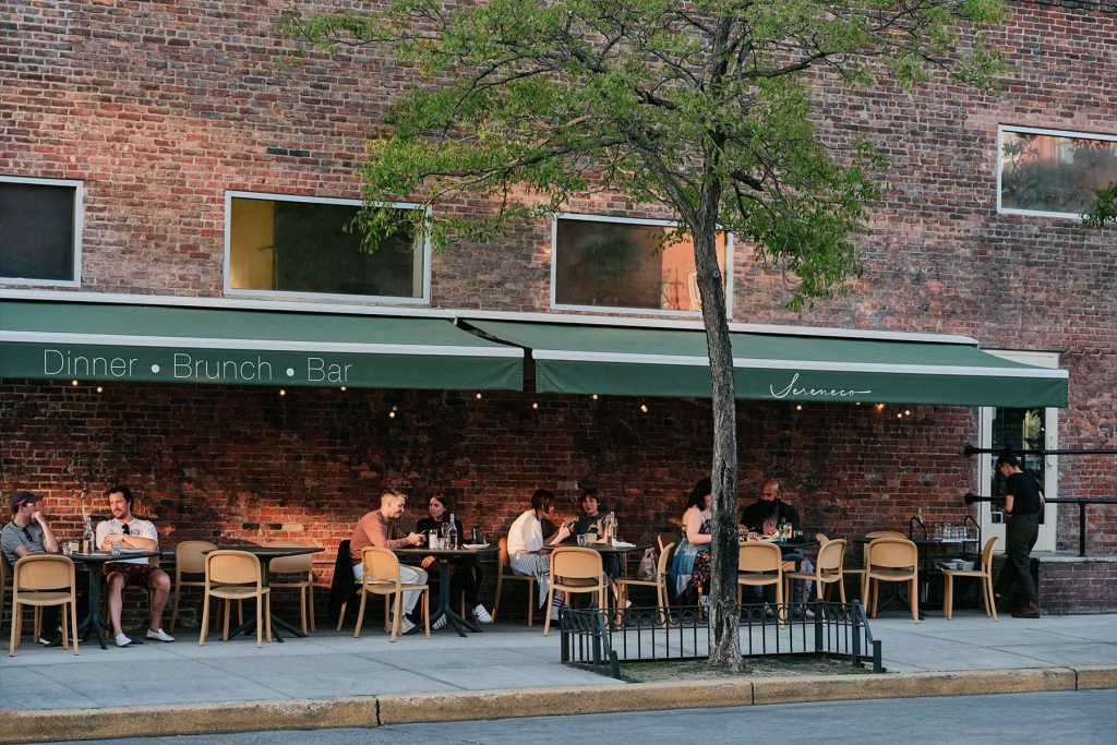 Greenpoint, Brooklyn. Sereneco restaurant with people dining outside.