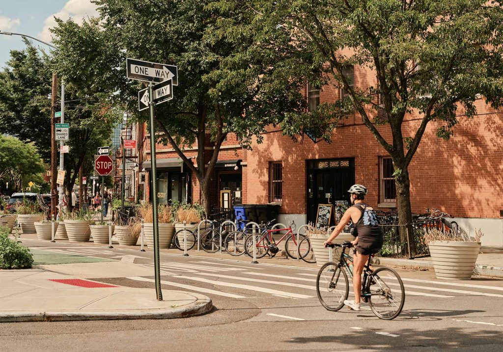 Greenpoint, Brooklyn neighborhood. Bicyclist crossing the street.